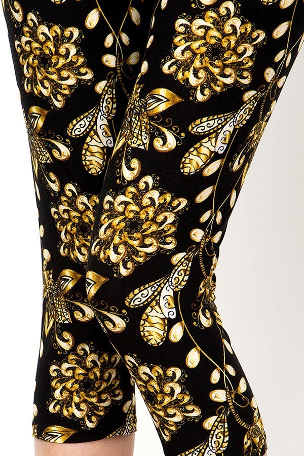 Black capri leggings with a gold coloured pattern