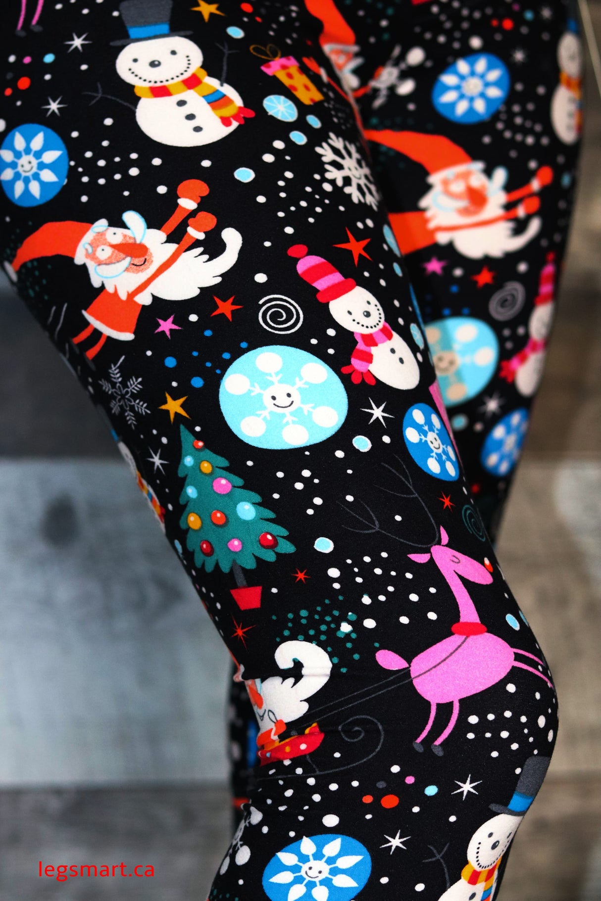 Black leggings with festive images of Santa, Christmas trees, Frosty and more