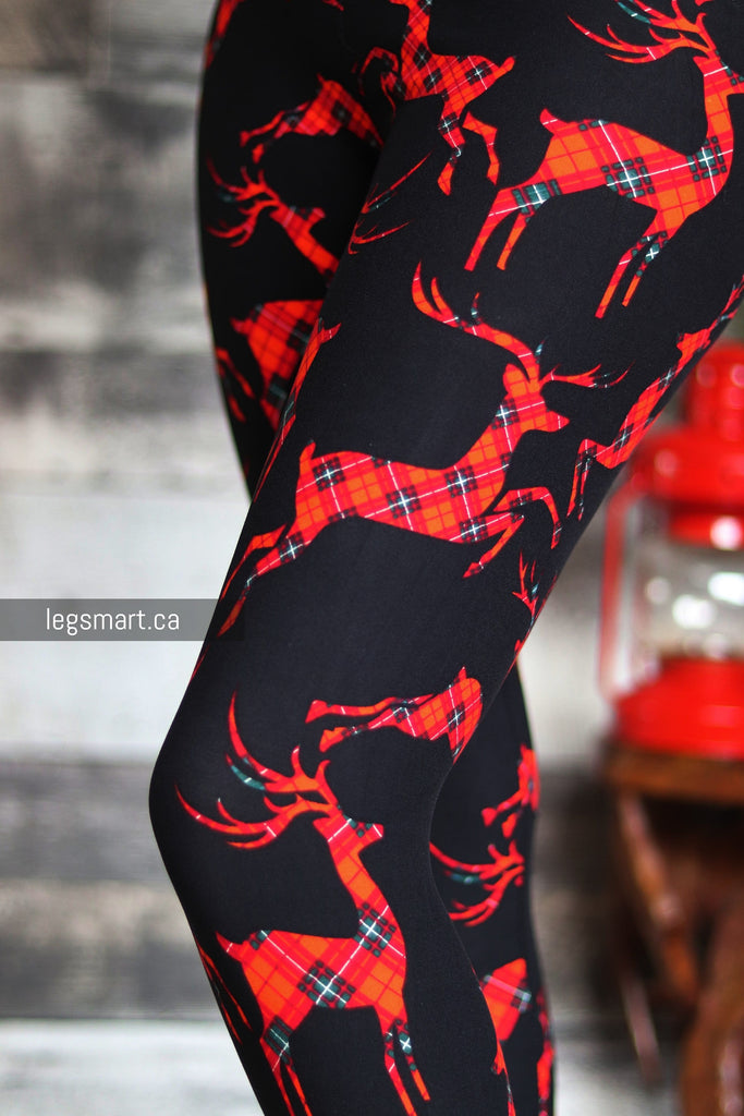 black leggings printed with red plaid reindeer 