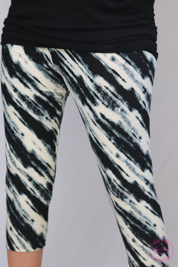 black and white capri leggings with a swirling design reminiscent of molten glass