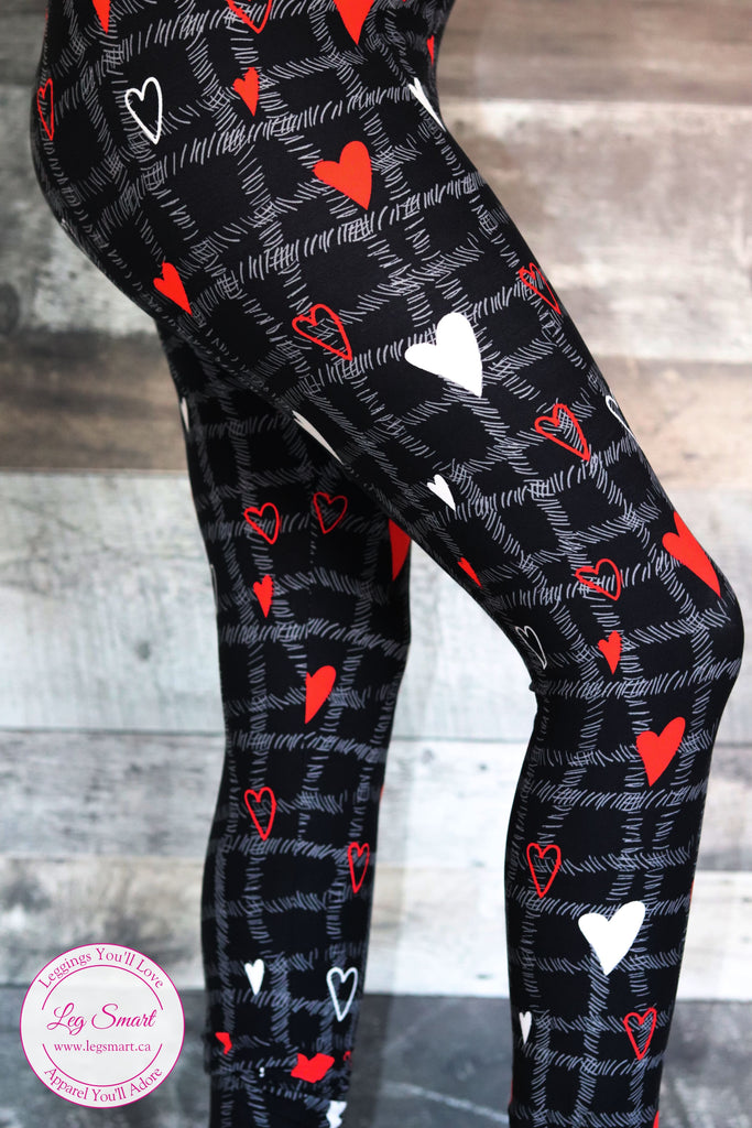 black leggings with a unique criss-cross design, these black leggings feature red and white hearts that are perfect for showing your love