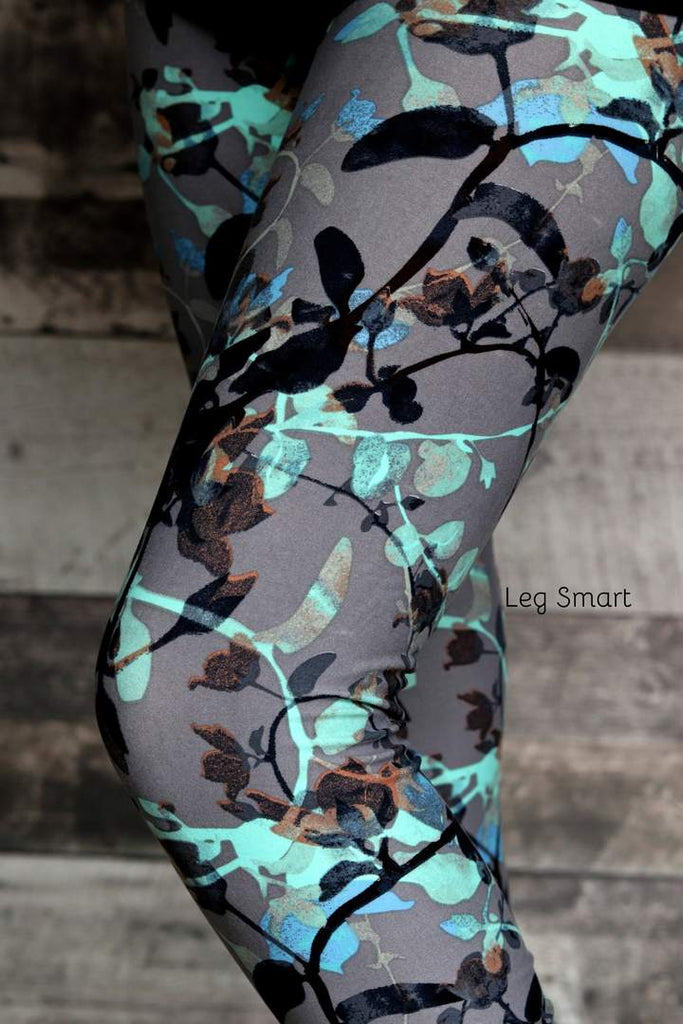 grey leggings with blue-green and black foliage print 