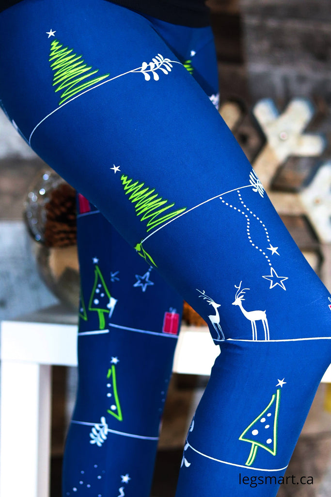 Blue Christmas leggings with a whimsical cartoon scene of Christmas Tree's, stars and reindeer
