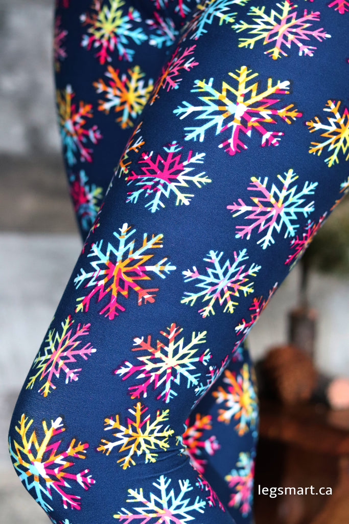 blue leggings printed with multi-colour snowflakes that resemble the appearance of looking through a kaleidoscope