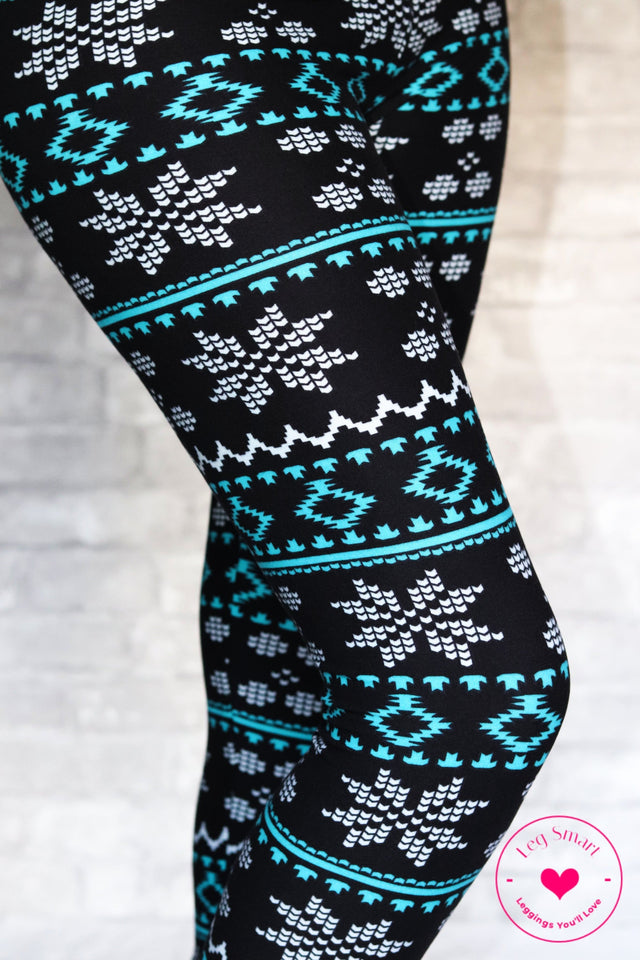 Classic black leggings with bright blue accents and white pixelated snowflakes