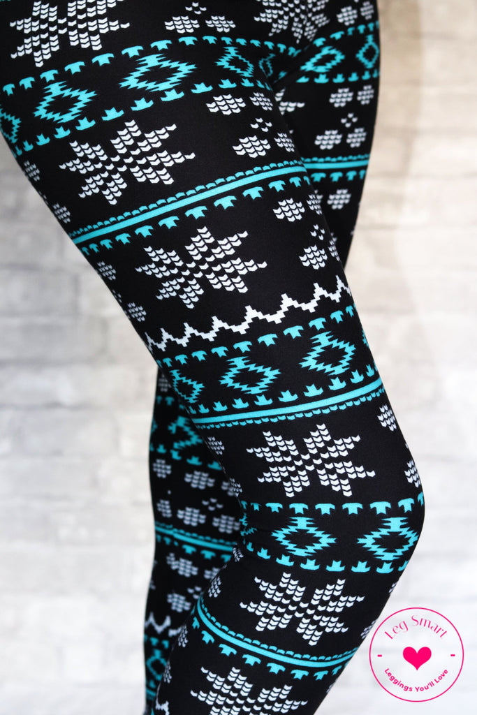 Classic black leggings with bright blue accents and white pixelated snowflakes