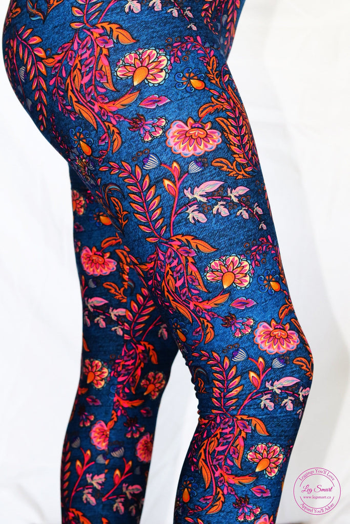 Rich blue leggings printed with a warm palette of oranges and pinks