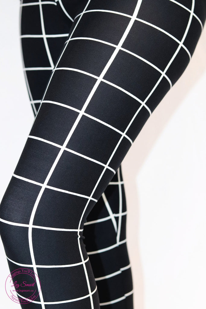 black leggings with horizontal and vertical white stripes